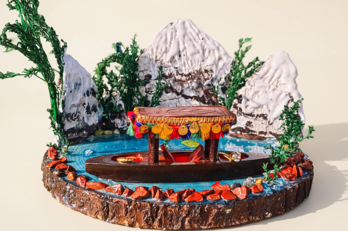 Decorative model of a mountainous landscape with a small building and colorful decorations.