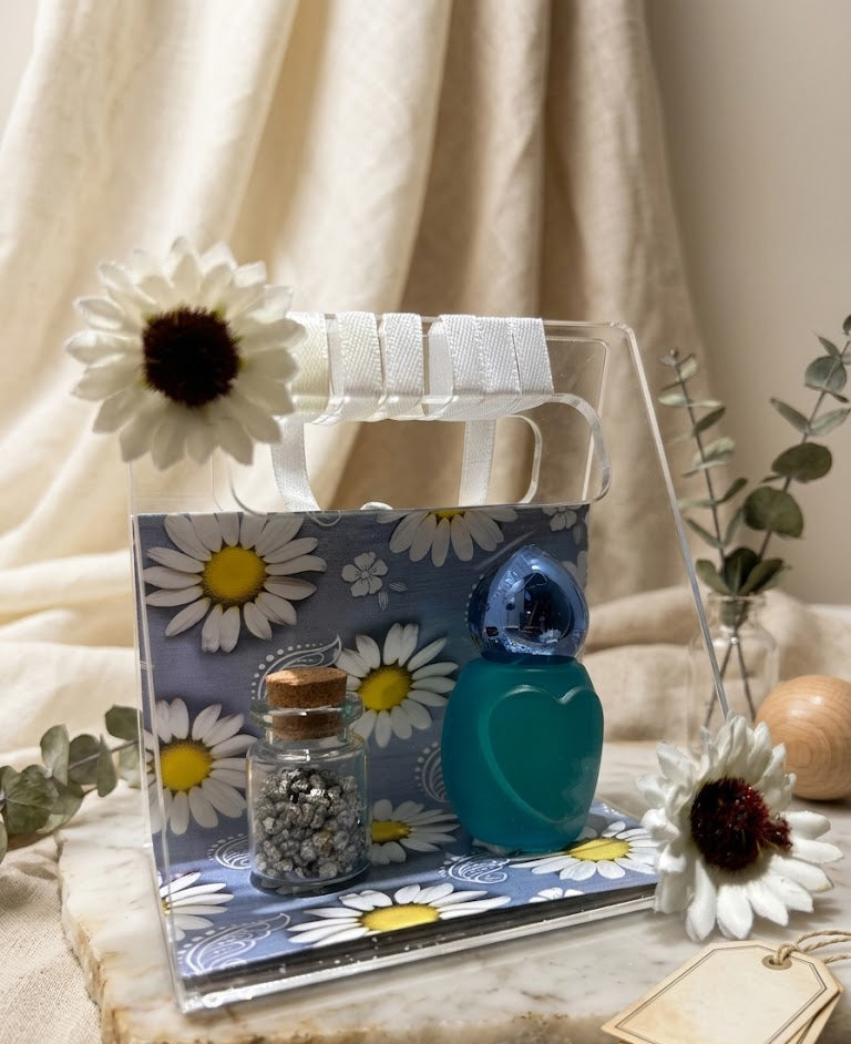 Clear acrylic stand with decorative items on a neutral background
