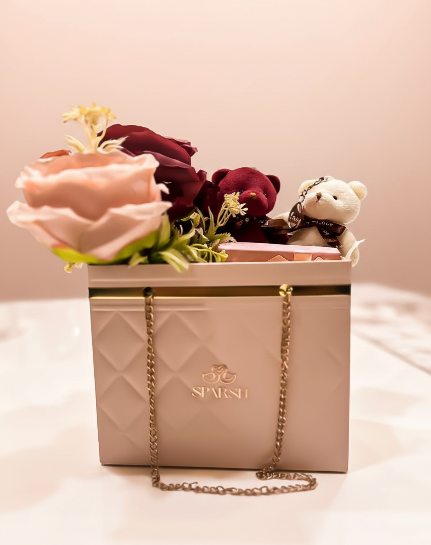 Decorative gift hampers with scented  flowers, teddy bears,  a surprise gift and chocolates. branded 'SPARSH' with peach color theme