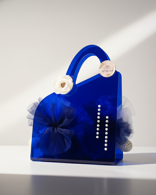 Blue decorative item resembling a handbag with floral elements on a white background