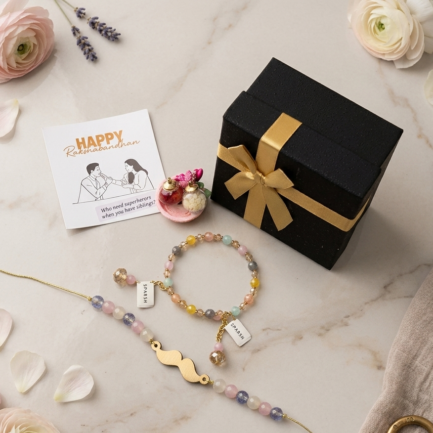 Two personalized beaded bracelets with gold charms are arranged on a light marble surface with decorative flowers, a small card reading 'Happy Restaurantman,' a black gift box with a gold ribbon, and a beige textured fabric.
