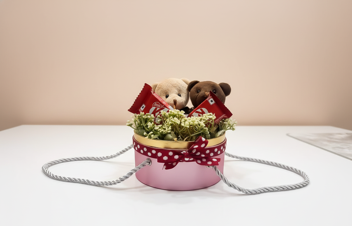 Decorative pot with flowers, small teddy bears, and red flags on a white surface.