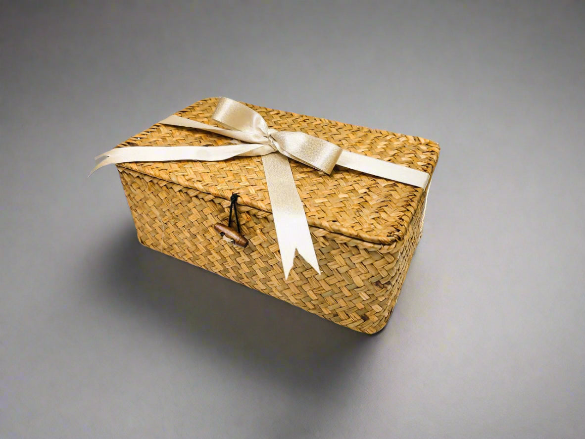 Woven basket with a ribbon on a white surface