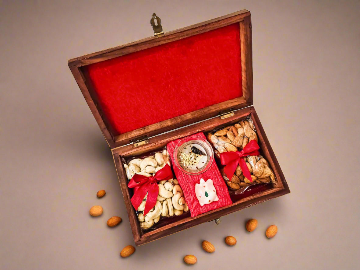 Wooden gift box with red interior, containing assorted dry fruits and a small decorative item and scented candle