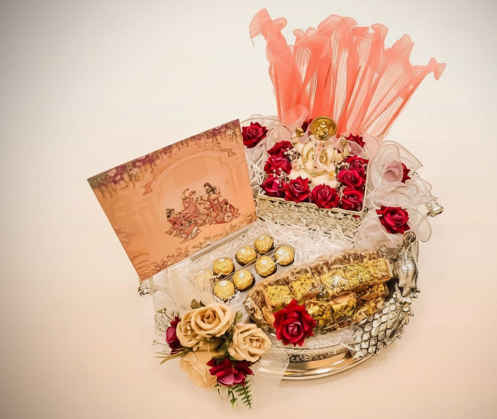 Decorative plate with flowers, snacks, and a card on a light background